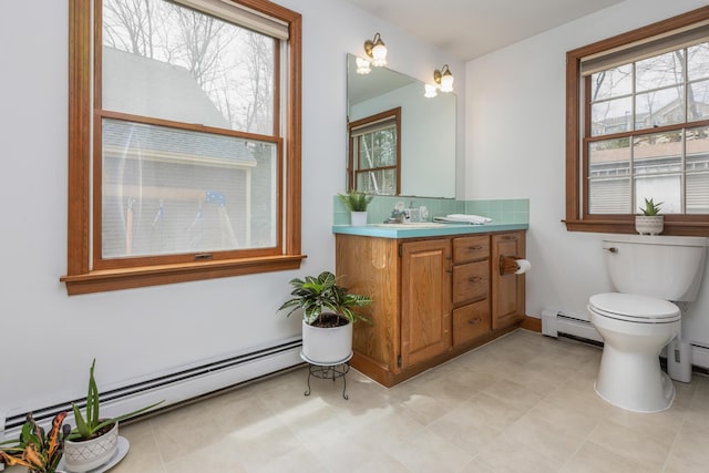 784 Ocean Ave, Portland, ME 04103 - bathroom featuring baseboard heating, plenty of natural light, and toilet