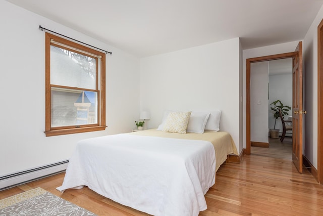 784 Ocean Ave, Portland, ME 04103 - bedroom with light wood-style flooring and a baseboard heating unit