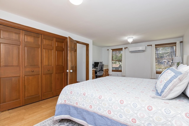 784 Ocean Ave, Portland, ME 04103 - bedroom with a wall unit AC, light wood-type flooring, and a closet