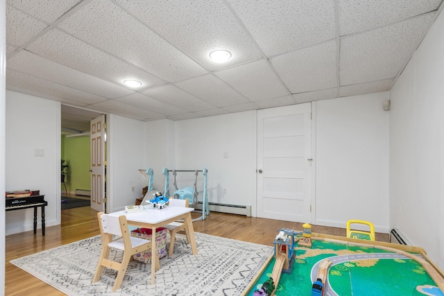 784 Ocean Ave, Portland, ME 04103 - game room with a baseboard heating unit, light wood-style floors, and a drop ceiling