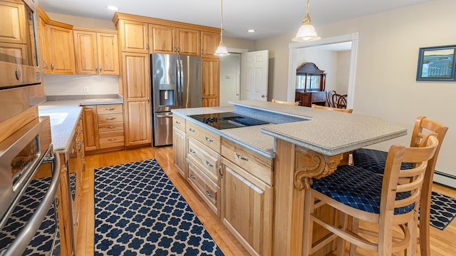 74 Town Farm Rd, Hampden, ME 04444 - kitchen featuring stainless steel appliances, light wood-style floors, a breakfast bar, a kitchen island, and recessed lighting