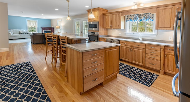 74 Town Farm Rd, Hampden, ME 04444 - kitchen with appliances with stainless steel finishes, light wood-type flooring, a kitchen island, a sink, and recessed lighting