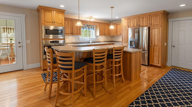 74 Town Farm Rd, Hampden, ME 04444 - kitchen featuring stainless steel appliances, a center island, light wood-style flooring, light countertops, and recessed lighting