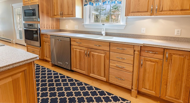 74 Town Farm Rd, Hampden, ME 04444 - kitchen with stainless steel appliances, a sink, a baseboard heating unit, light countertops, and light wood-style floors