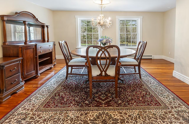 74 Town Farm Rd, Hampden, ME 04444 - dining room with dark wood-type flooring, baseboards, and a chandelier