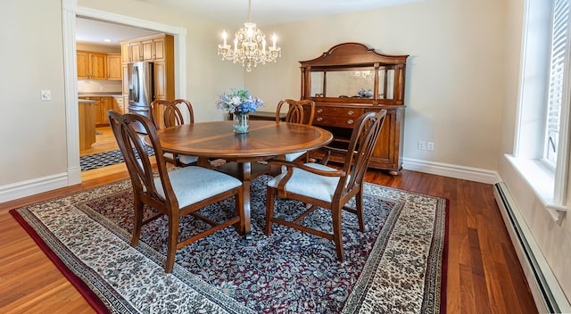 74 Town Farm Rd, Hampden, ME 04444 - dining space with baseboard heating, a chandelier, light wood-style flooring, and baseboards