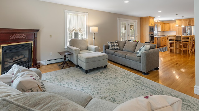 74 Town Farm Rd, Hampden, ME 04444 - living area featuring a baseboard radiator, light wood-style flooring, recessed lighting, a glass covered fireplace, and baseboards