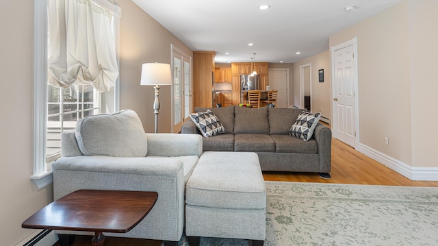 74 Town Farm Rd, Hampden, ME 04444 - living room featuring light wood finished floors, baseboards, plenty of natural light, a baseboard heating unit, and recessed lighting