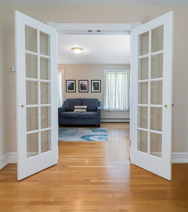 74 Town Farm Rd, Hampden, ME 04444 - living area featuring a baseboard radiator, light wood finished floors, and french doors