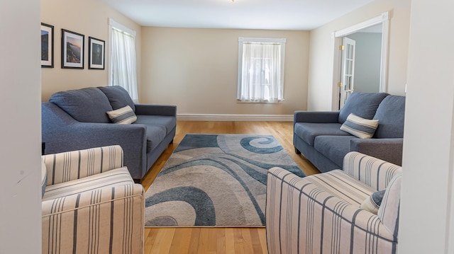 74 Town Farm Rd, Hampden, ME 04444 - living area with healthy amount of natural light, baseboards, and wood finished floors