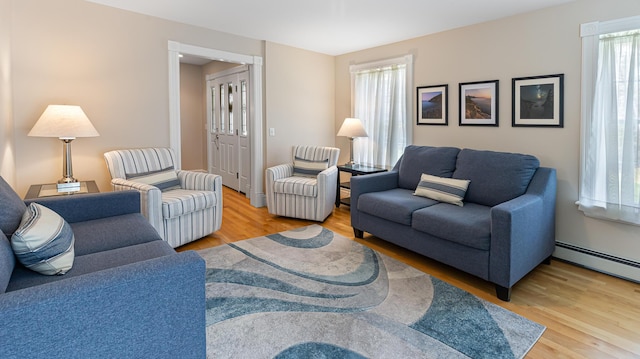 74 Town Farm Rd, Hampden, ME 04444 - living area with wood finished floors and a baseboard heating unit