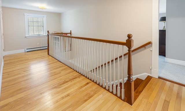 74 Town Farm Rd, Hampden, ME 04444 - stairs with baseboard heating, wood-type flooring, and baseboards