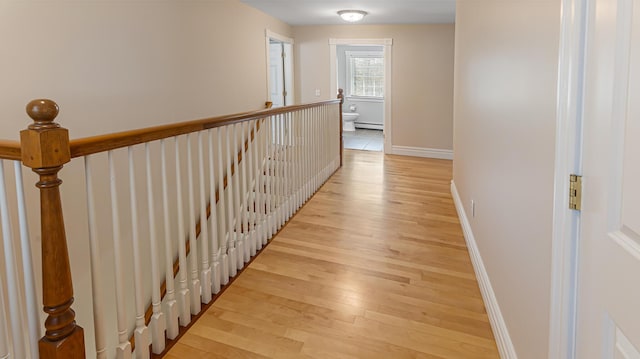 74 Town Farm Rd, Hampden, ME 04444 - hall featuring light wood finished floors, a baseboard radiator, baseboards, and an upstairs landing