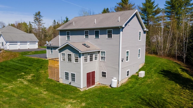 74 Town Farm Rd, Hampden, ME 04444 - back of house featuring a yard, a garage, and a shingled roof