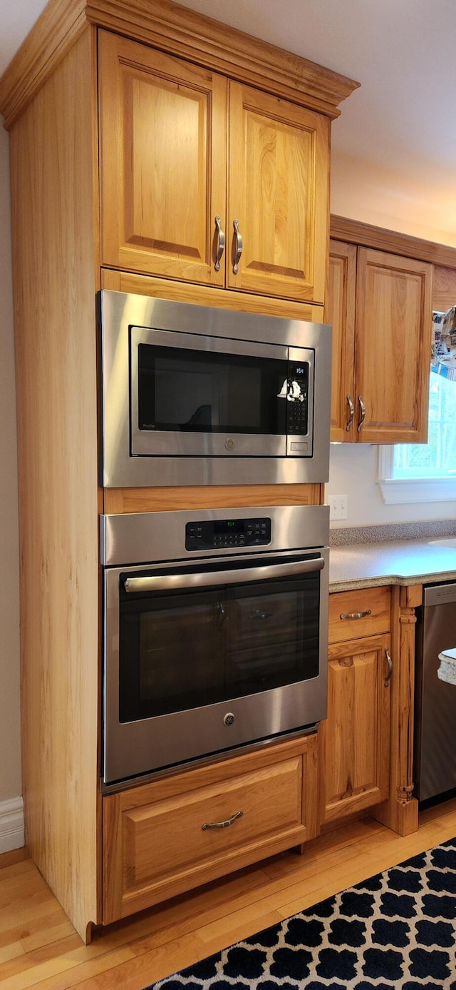 74 Town Farm Rd, Hampden, ME 04444 - kitchen featuring stainless steel appliances, light wood-type flooring, light countertops, and brown cabinetry
