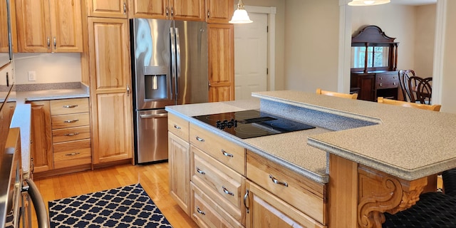 74 Town Farm Rd, Hampden, ME 04444 - kitchen featuring stainless steel refrigerator with ice dispenser, black electric cooktop, light wood finished floors, and light countertops