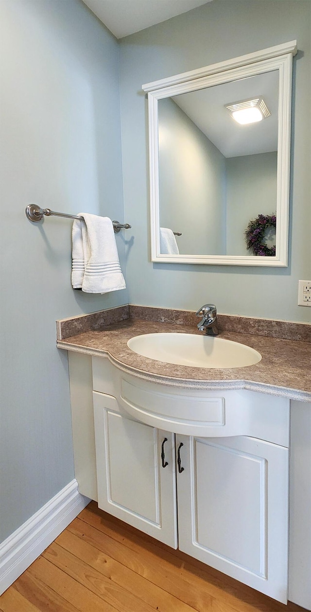 74 Town Farm Rd, Hampden, ME 04444 - bathroom with wood finished floors and vanity