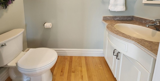 74 Town Farm Rd, Hampden, ME 04444 - bathroom featuring toilet, vanity, wood finished floors, and baseboards