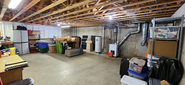 74 Town Farm Rd, Hampden, ME 04444 - unfinished below grade area featuring water heater and a heating unit