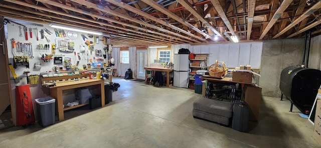 74 Town Farm Rd, Hampden, ME 04444 - below grade area with heating fuel and a workshop area