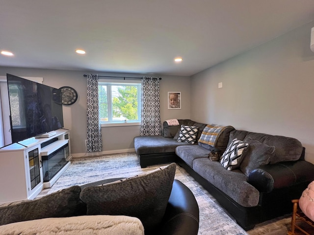 99 St John Rd, Fort Kent, ME 04743 - living room featuring wood finished floors, baseboards, a glass covered fireplace, and recessed lighting