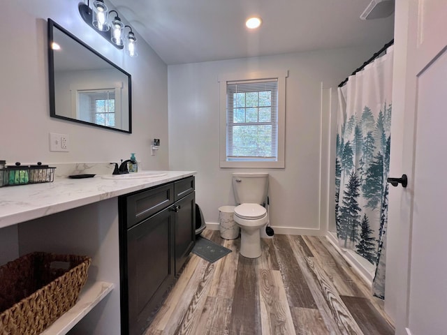 99 St John Rd, Fort Kent, ME 04743 - full bath with toilet, baseboards, curtained shower, vanity, and wood finished floors