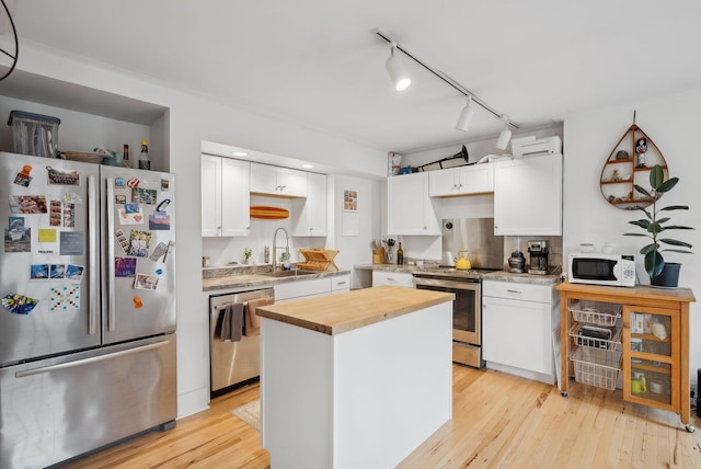 17 Pine St Unit 3, Portland, ME 04102 - kitchen with stainless steel appliances, a sink, butcher block counters, and white cabinets