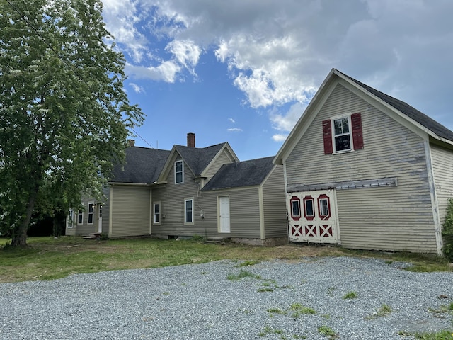 168 Guzzle Rd, Gouldsboro, ME 04607 - view of front facade with a chimney, a shingled roof, and a barn