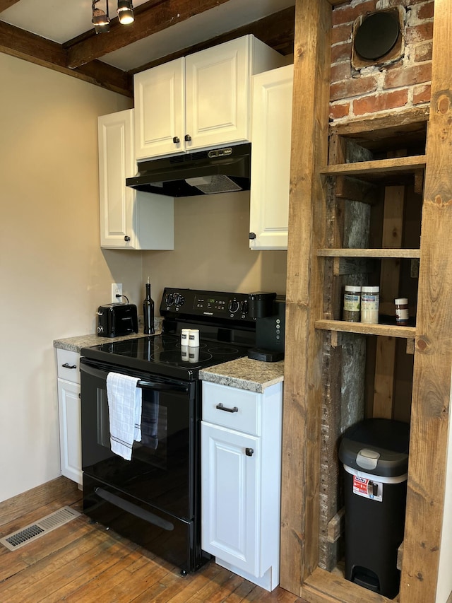 168 Guzzle Rd, Gouldsboro, ME 04607 - kitchen featuring wood-type flooring, black electric range, white cabinetry, visible vents, and under cabinet range hood