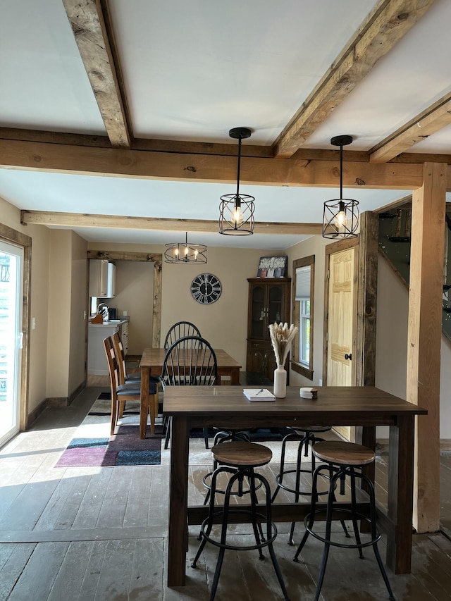 168 Guzzle Rd, Gouldsboro, ME 04607 - dining area with baseboards, hardwood / wood-style floors, and beam ceiling