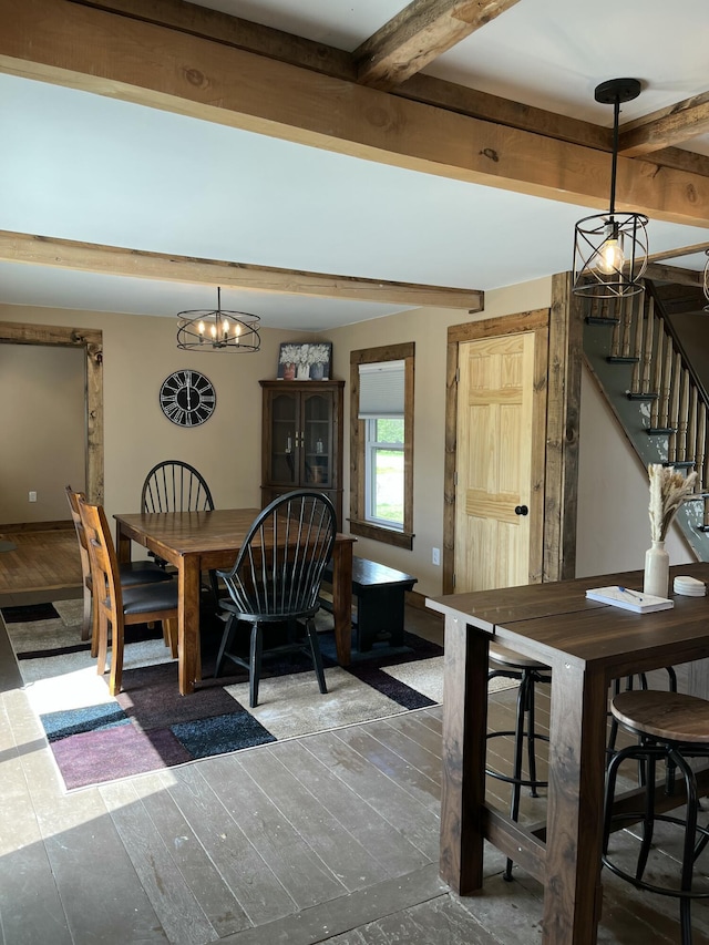 168 Guzzle Rd, Gouldsboro, ME 04607 - dining space with stairs, beamed ceiling, an inviting chandelier, and wood finished floors