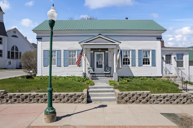 98 Main St, Winthrop, ME 04364 - view of front of property with metal roof and a front lawn