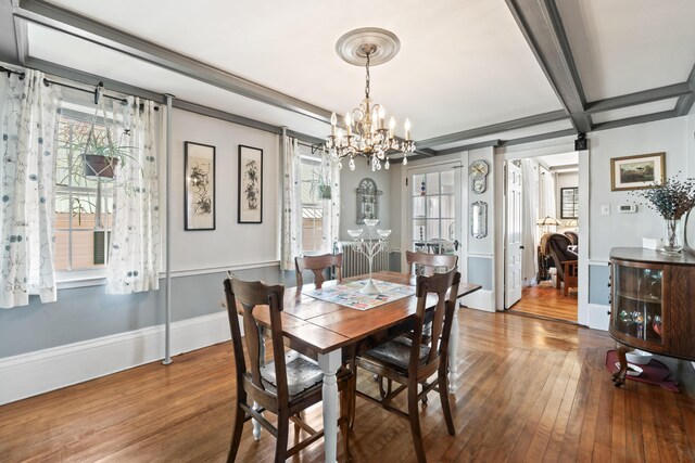 98 Main St, Winthrop, ME 04364 - dining space with a chandelier, hardwood / wood-style flooring, beam ceiling, baseboards, and coffered ceiling