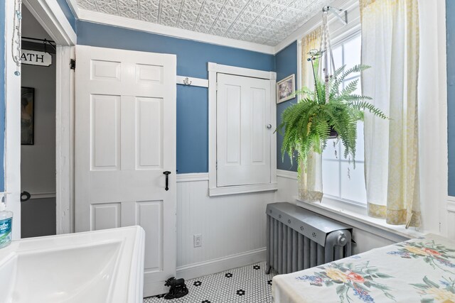 98 Main St, Winthrop, ME 04364 - bedroom featuring an ornate ceiling, radiator heating unit, a wainscoted wall, baseboards, and ornamental molding