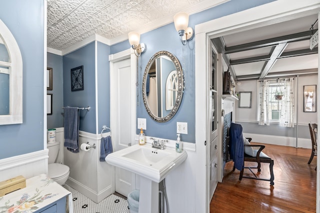 98 Main St, Winthrop, ME 04364 - bathroom featuring wainscoting, an ornate ceiling, wood finished floors, toilet, and crown molding