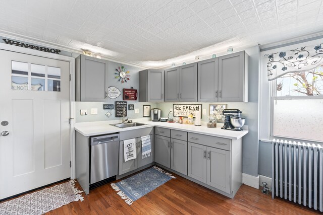 98 Main St, Winthrop, ME 04364 - kitchen with radiator heating unit, dishwasher, gray cabinetry, a sink, and light countertops