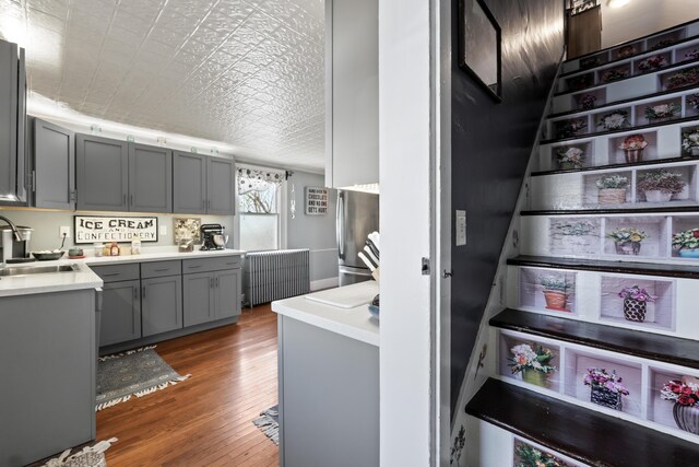 98 Main St, Winthrop, ME 04364 - staircase with radiator heating unit, wood finished floors, and an ornate ceiling