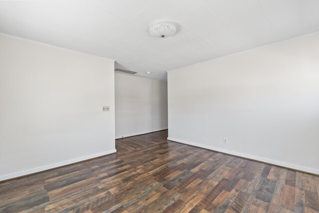 98 Main St, Winthrop, ME 04364 - empty room featuring dark wood-type flooring, crown molding, and baseboards