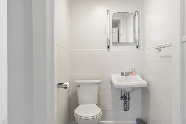 98 Main St, Winthrop, ME 04364 - bathroom with tile walls, toilet, and wainscoting