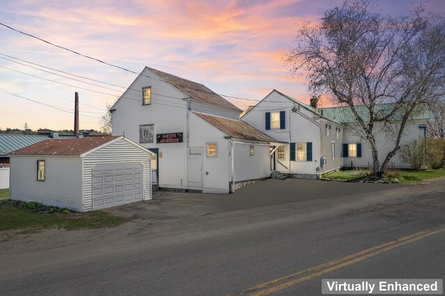 98 Main St, Winthrop, ME 04364 - view of front of property with a garage, an outbuilding, and dirt driveway
