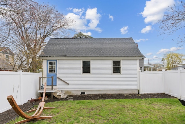 60 Grove St, Wells, ME 04090 - rear view of property featuring a yard, a shingled roof, and a fenced backyard