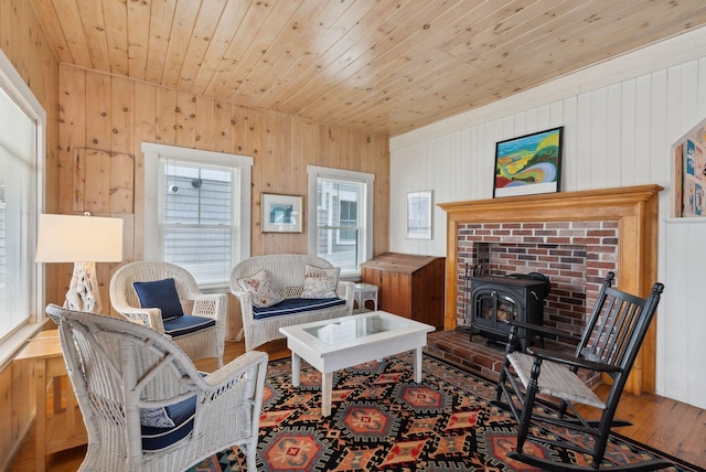 60 Grove St, Wells, ME 04090 - living area with a wood stove, a wealth of natural light, and wood walls