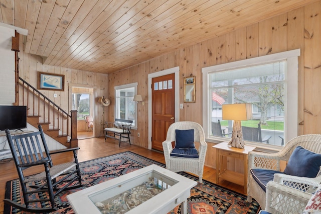 60 Grove St, Wells, ME 04090 - living room with stairs, wooden walls, wood ceiling, and wood finished floors