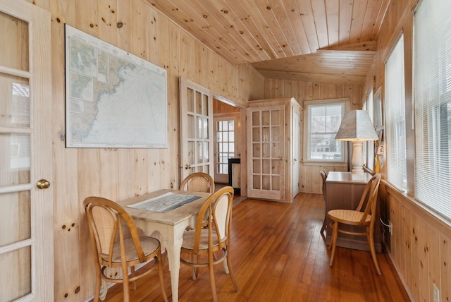 60 Grove St, Wells, ME 04090 - dining room with wooden walls, wood-type flooring, wood ceiling, and french doors
