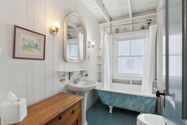 60 Grove St, Wells, ME 04090 - bathroom featuring toilet, a sink, beam ceiling, a shower with shower curtain, and a washtub