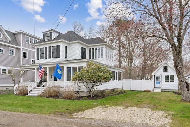 60 Grove St, Wells, ME 04090 - view of front of house with a porch, roof with shingles, fence, and a front lawn