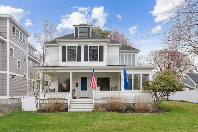 60 Grove St, Wells, ME 04090 - traditional style home featuring a porch, roof with shingles, fence, and a front lawn