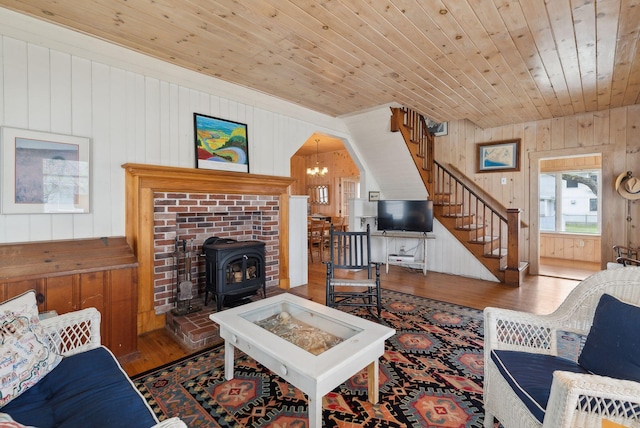 60 Grove St, Wells, ME 04090 - living area featuring wood walls, wood finished floors, a wood stove, stairway, and wood ceiling