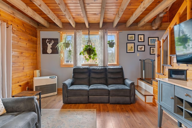 397 New Bridge Rd, Acton, ME 04001 - living area with heating unit, hardwood / wood-style floors, wood ceiling, beam ceiling, and baseboards