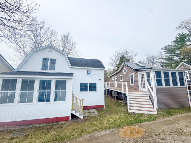 108 Sandy Beach Rd Unit D, Glenburn, ME 04401 - rear view of house with entry steps, stairway, a wooden deck, and a shingled roof